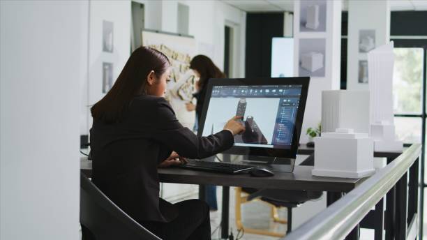 istock Architect reviewing residential area building plans on pc 1969805283
