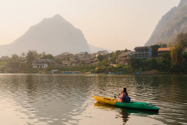 istock Woman canoeing on Mekong river in Laos 1969811085