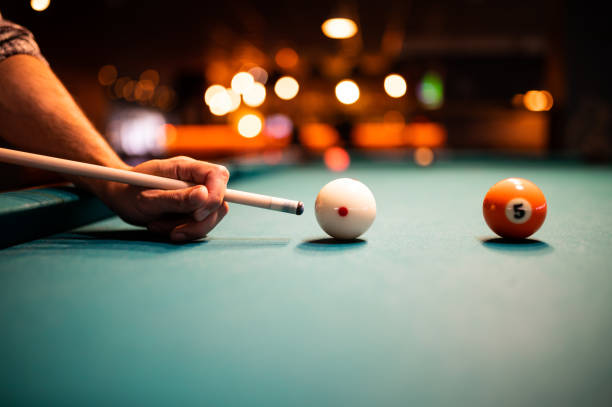 istock Young man playing snooker, aiming. for a good shot 1969811617