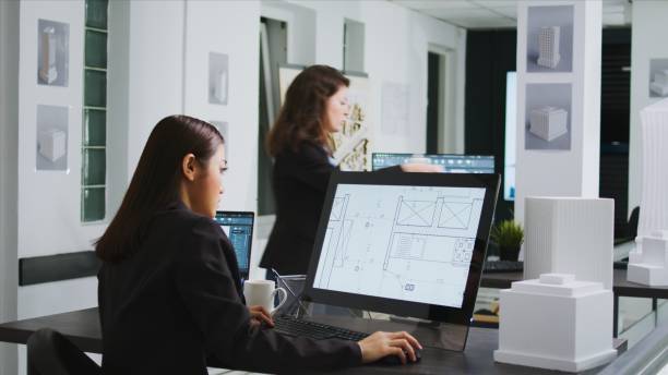 istock Asian graphic artist designing floor plan blueprint 1969812149