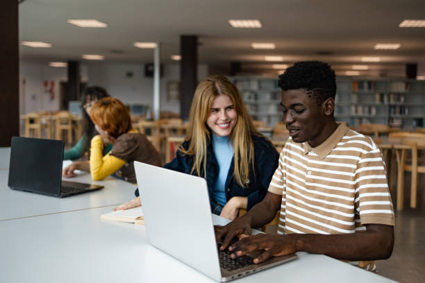 istock Young people studying together in university library - School education concept 1969822271
