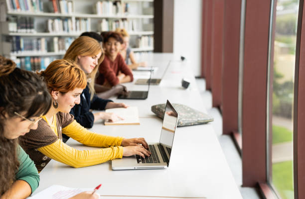 istock Young multiracial people studying in library - School education concept 1969822832