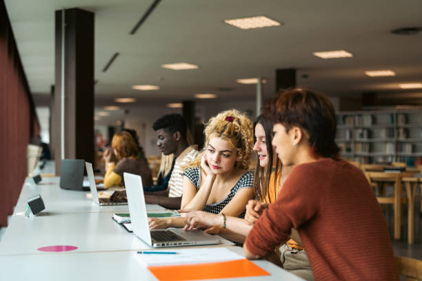 istock Young multiracial people studying in library - School education concept 1969823873