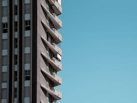 A modern building in Calpe, Alicante, set against a vibrant blue sky