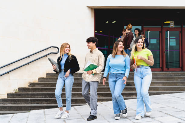 istock Young diverse students leaving university after lesson - Youth and education concept 1969831965