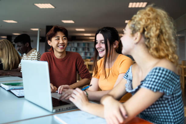 istock Young multiracial people studying together inside university library - School education concept 1969832522