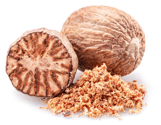 istock Nutmeg and ground nutmeg heap isolated on white background. 1969836332