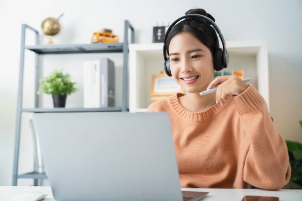 istock Young attractive female sitting at the desk and using laptop computer. 1969840617