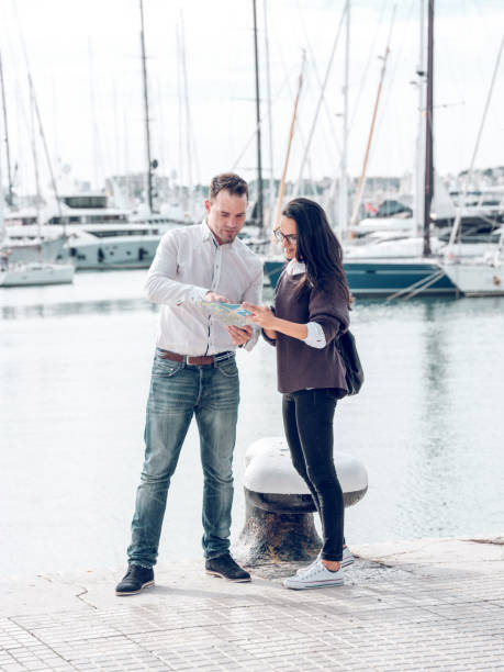 istock Man helping woman to find location on map 1969850806