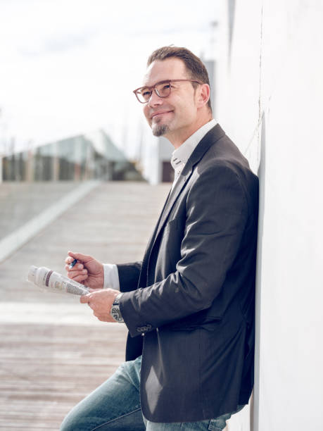 istock Dreamy man writing in newspaper in city 1969853969