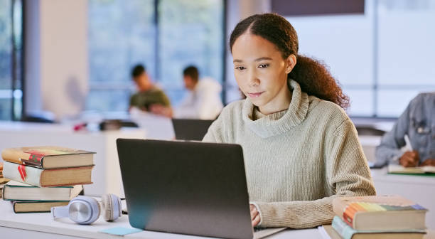 istock Laptop, college classroom and woman reading online research study on philosophy info, knowledge or education. University, academy and student working on problem solving solution of school project 1969855034