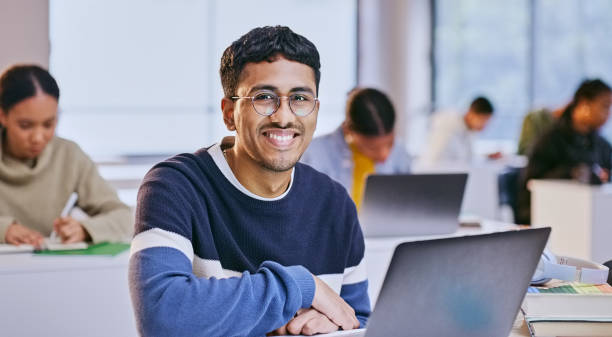 istock College portrait, happiness and man doing classroom project, research or working on education course. University, Indian teen and student smile for scholarship, learning development or campus study 1969855069