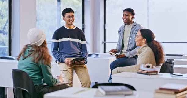 istock College, group and students talking about research in meeting, collaboration and support for study. University, community and friends learning together with conversation of project or education 1969855611