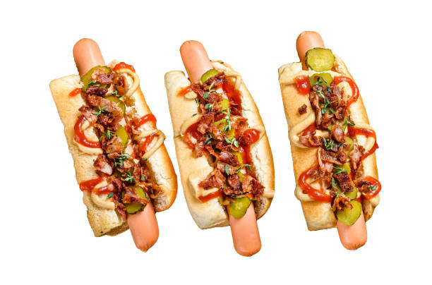istock Hot dogs fully loaded with fried bacon, onion and pickled cucumbers.  Isolated on white background. Top view. 1969857890