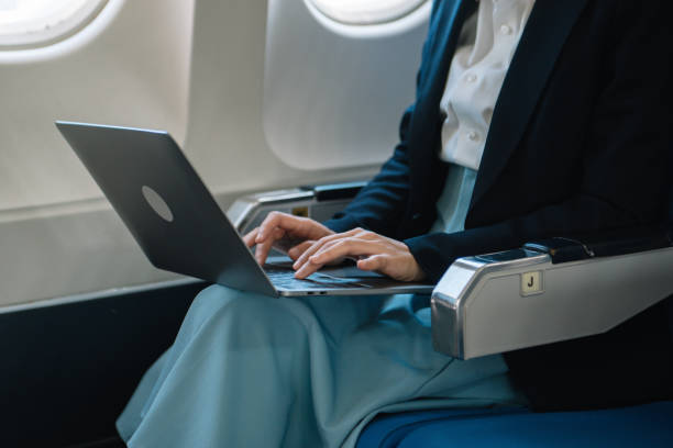istock Business woman sitting front tablet ,laptop computer with financial graphs and statistics on monitor 1969860071