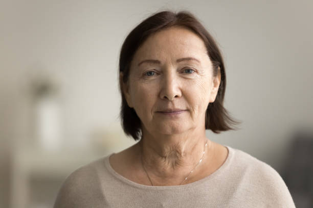 Indoor head shot portrait of serious positive old mature woman Indoor head shot portrait of serious positive old mature woman in casual looking at camera, posing at home, promoting retirement, elderly healthcare. Senior grandmother woman video call screen head shoot stock pictures, royalty-free photos & images