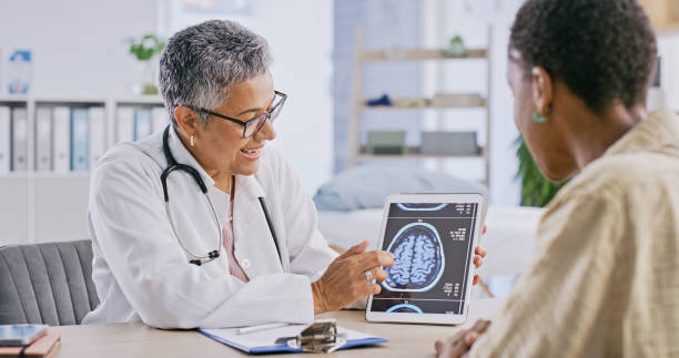 Healthcare, tablet for brain scan and doctor with patient at appointment or checkup for diagnosis. Medicine, consulting or mri results with medical professional and woman in hospital for discussion stock photo