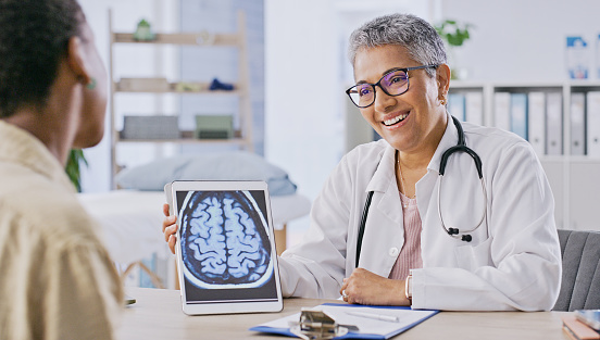 Healthcare, happy at brain scan and doctor with patient in office for appointment, checkup or diagnosis. Smile, consulting or mri result with medical professional and woman in hospital for discussion