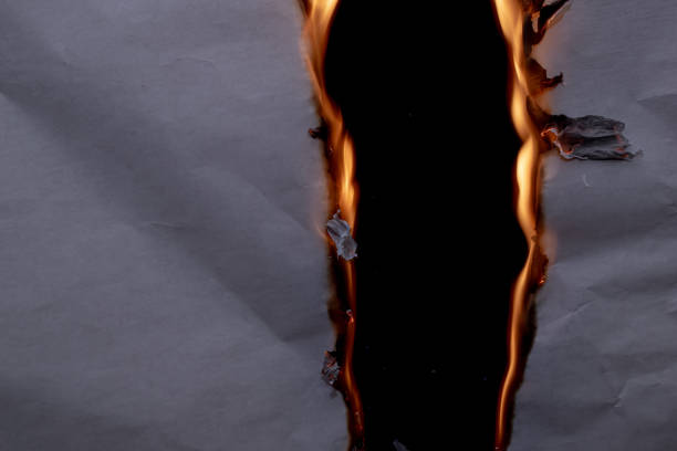 istock burning paper, glowing edge of paper 1969865530