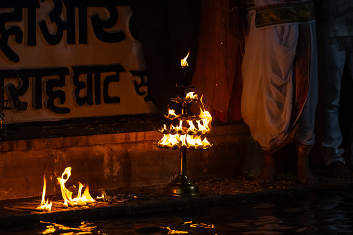 Pushkar, Rajasthan, India - November 2022: Fire flames near holy lake sarovar post evening aarti at pushkar.