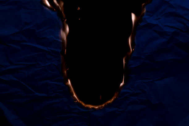 burning paper, glowing edge of paper on a black background