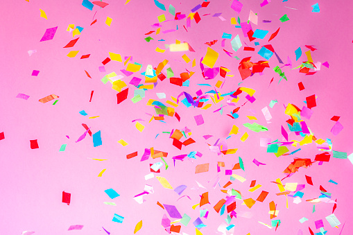 Falling confetti on pink background. High resolution 42Mp studio digital capture taken with Sony A7rII and Sony FE 90mm f2.8 macro G OSS lens