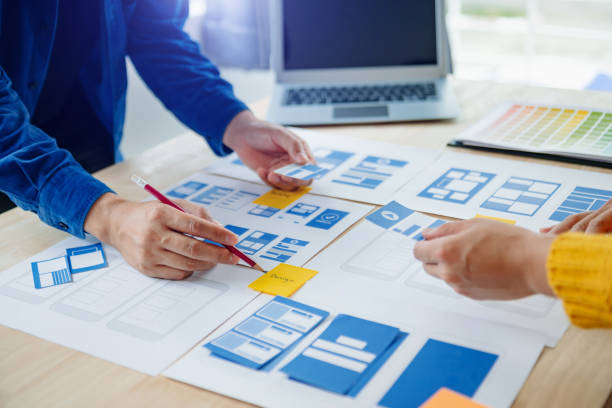 istock View of UI developer team brainstorming on their project with laptop, smartphone and digital tablet. Creative digital development agency. 1969874189