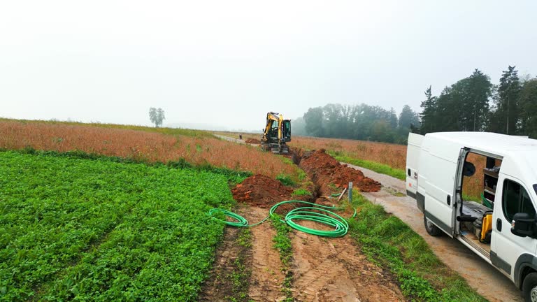 aerial of laying fiber optic cable in rural area