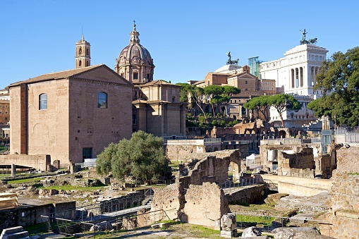 Trajan's Column at the Imperial Forums in Rome with the Basilica of the XII Santi Apostoli in the background