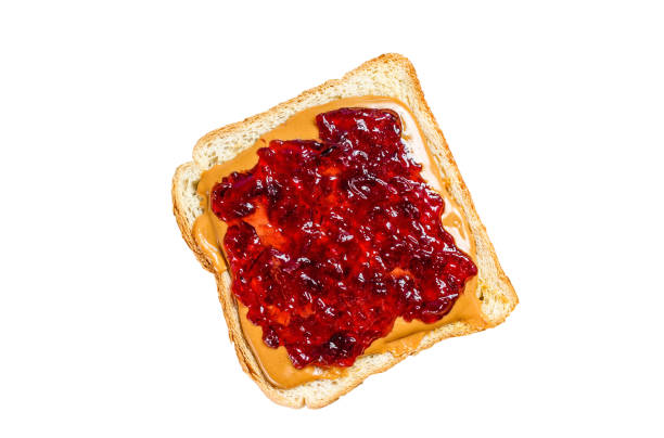 istock Peanut butter and jelly on white bread toasts.   Isolated on white background. Top view. 1969942126