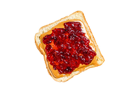 Peanut butter and jelly on white bread toasts.   Isolated on white background. Top view