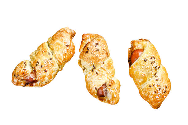Cutting board with sausage rolls  in the dough.   Isolated on white background. Top view