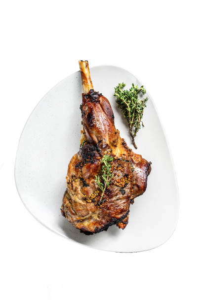 istock BBQ lamb leg with herbs.   Isolated on white background. Top view. 1969942510
