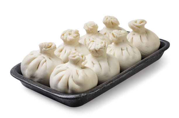 Khinkali in a plastic tray close-up on a white background. Isolated