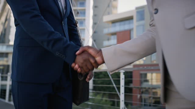 Business people, welcome and handshake for city meeting, partnership or b2b collaboration deal closeup. Thank you, zoom and men shaking hands outdoor with support, cooperation or negotiation success