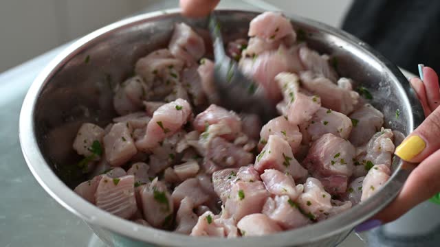 Peruvian food ceviche. 3 Preparation of ceviche, stirring the seasonings with the coriander.