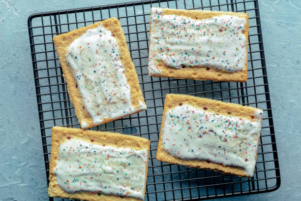 istock Pop tarts on a baking rack. Poptart toaster pastry with icing on blue 1970017527