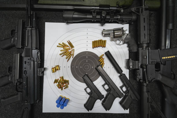 Firearms, tactical guns, rifles, pistols and a shooting target. High quality photo