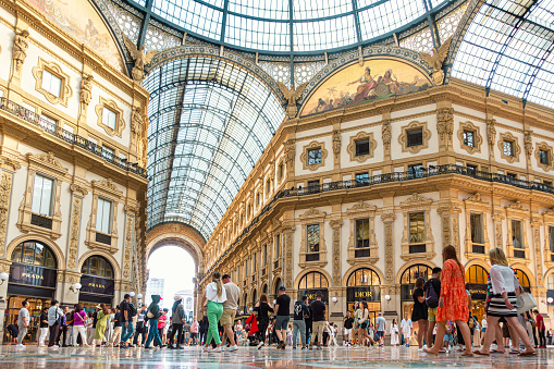 Milan, people and fashion shops in Galleria Vittorio Emanuele II with people.