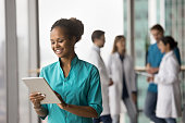 Cheerful young African American medical worker using online healthcare application