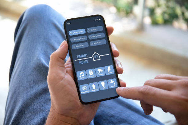 istock male hands holding phone with application smart home on screen 1970051085