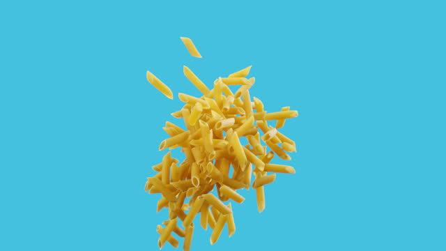 Super slow motion yellow Rigatoni tube pasta noodles jumping tossed in the air cut out on blue background
