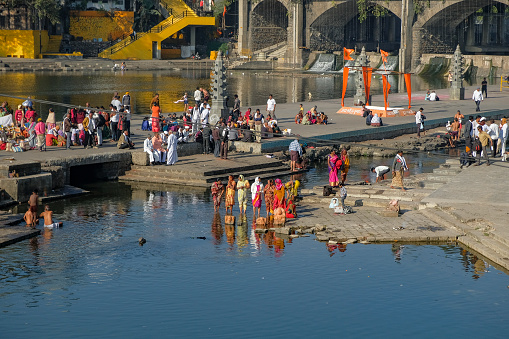 Nashik, India - January 25, 2024: People making offerings at the Ganga Ghat in Nashik, India.