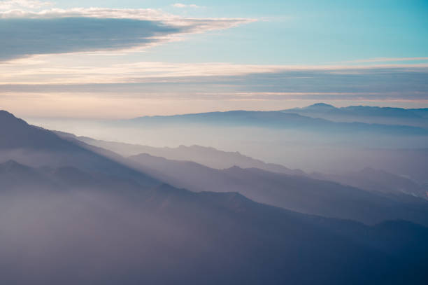 istock Clouds and mist rolled over the valley. Blue sky, white clouds, sunshine. 1970092890