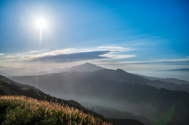 Clouds and mist rolled over the valley. Blue sky, white clouds, sunshine. Warm winter mountain scenery in northern Taiwan, Shuangxi Buyanting Pavilion.