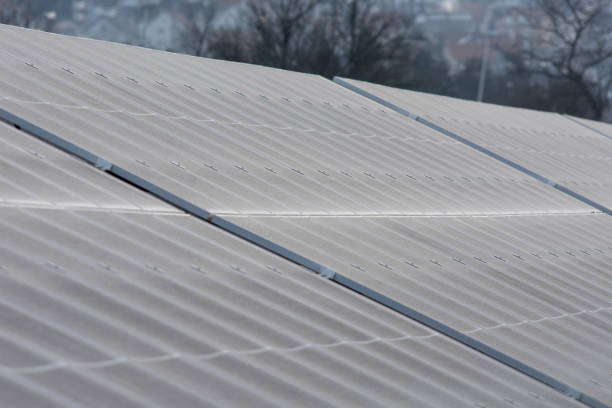 istock Oblique view of solar panel surfaces with morning frost 1970096540