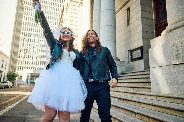 overjoyed couple celebrating their elopement wedding in the city. - bride wedding freedom arms raised imagens e fotografias de stock