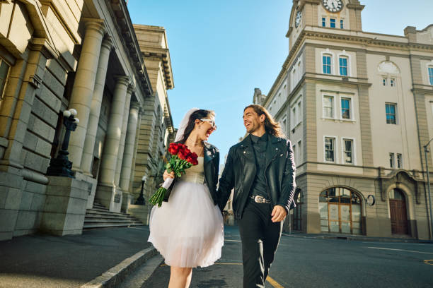 overjoyed couple celebrating their elopement wedding in the city. - bride wedding freedom arms raised zdjęcia i obrazy z banku zdjęć