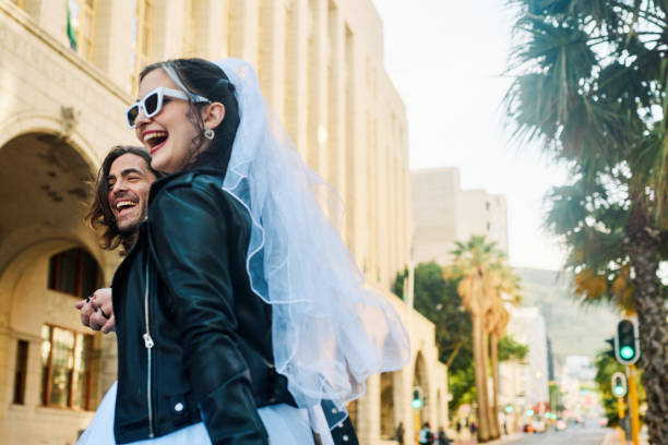 overjoyed couple celebrating their elopement wedding in the city. - bride wedding freedom arms raised imagens e fotografias de stock