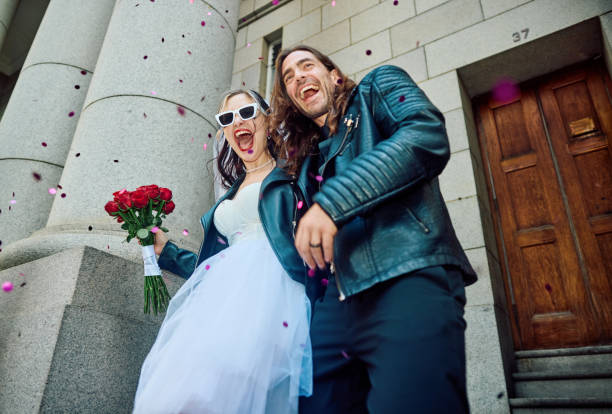 overjoyed couple celebrating their elopement wedding in the city. - bride wedding freedom arms raised zdjęcia i obrazy z banku zdjęć
